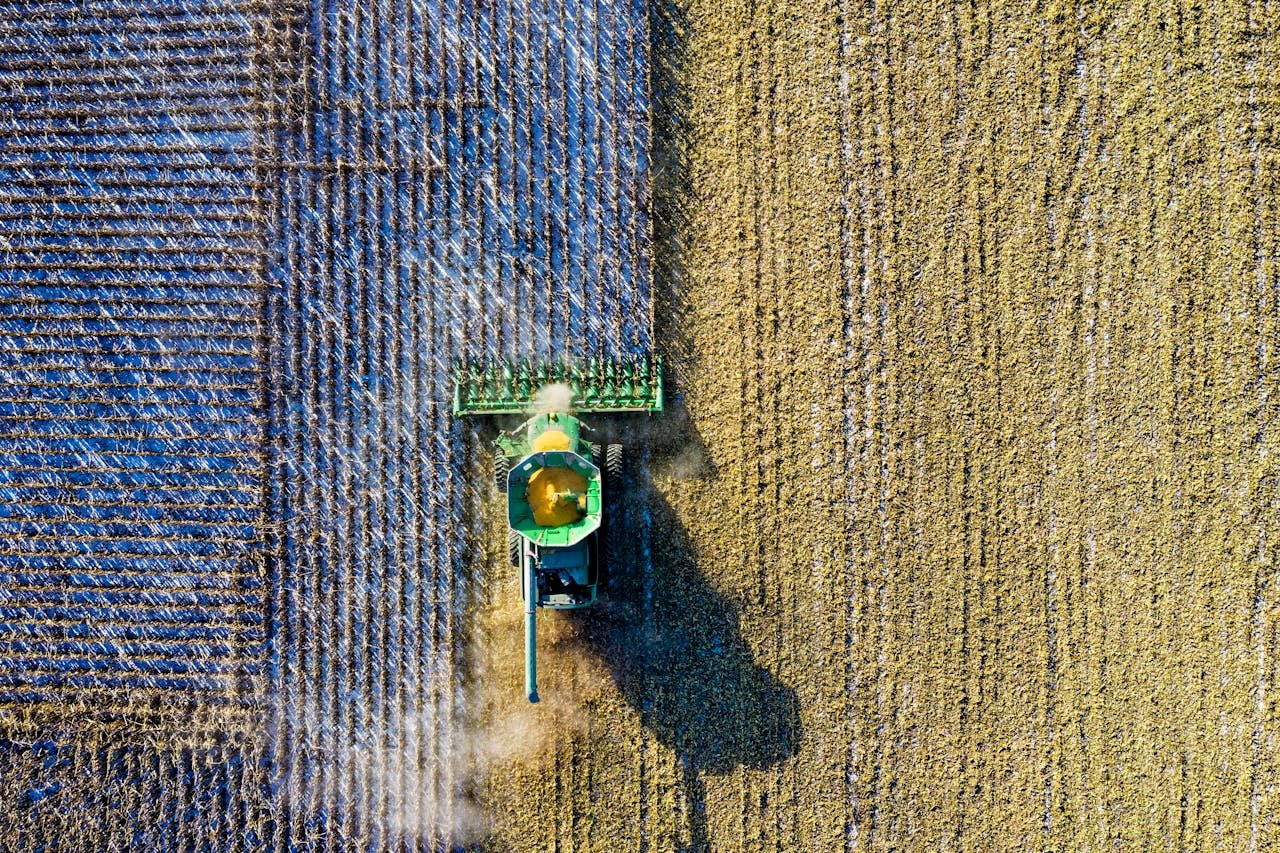 services-img Aerial drone shot of a combine harvester working in a cornfield during harvest season in rural Minnesota.